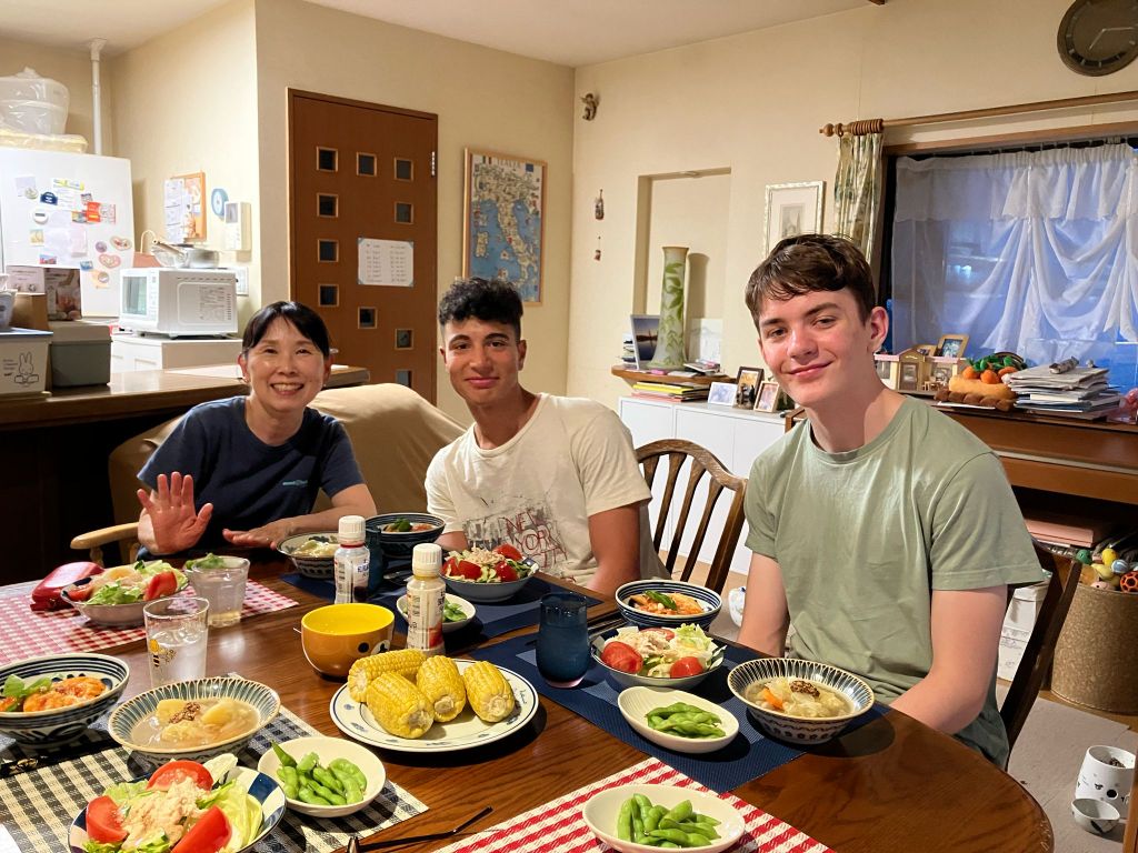 Students enjoying meal together at homestay